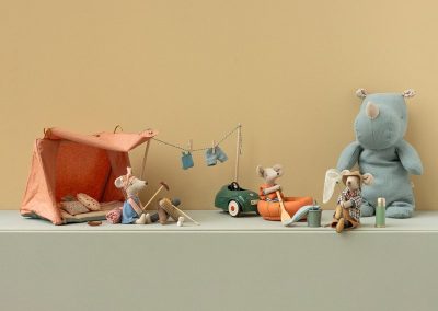 outdoor camping scene with tent, hiker mouse, rubber boat and mouse fishing