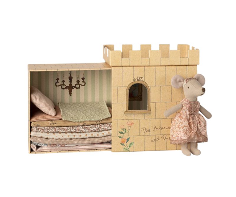 princess big sister in a pink dress beside her castle bed which has layers of matresses and a pea